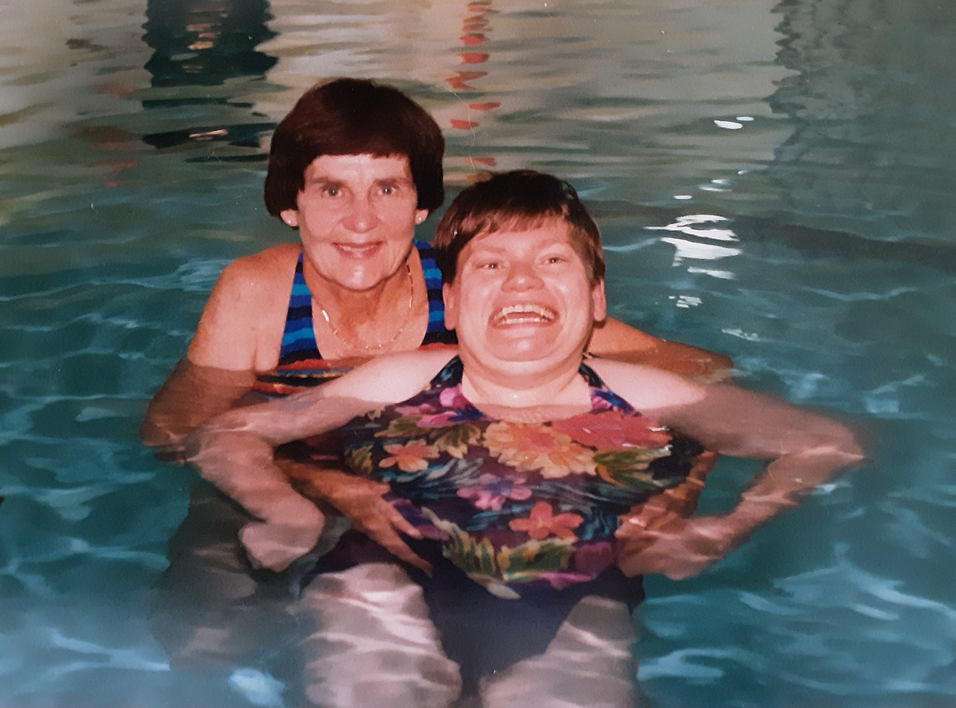 Photo is Bette in the pool in 1997 with Sharon, a person who is supported by Ongwanada.