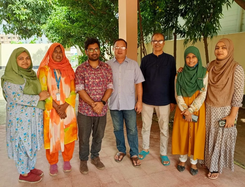 Krishno stands with six colleagues from CDD