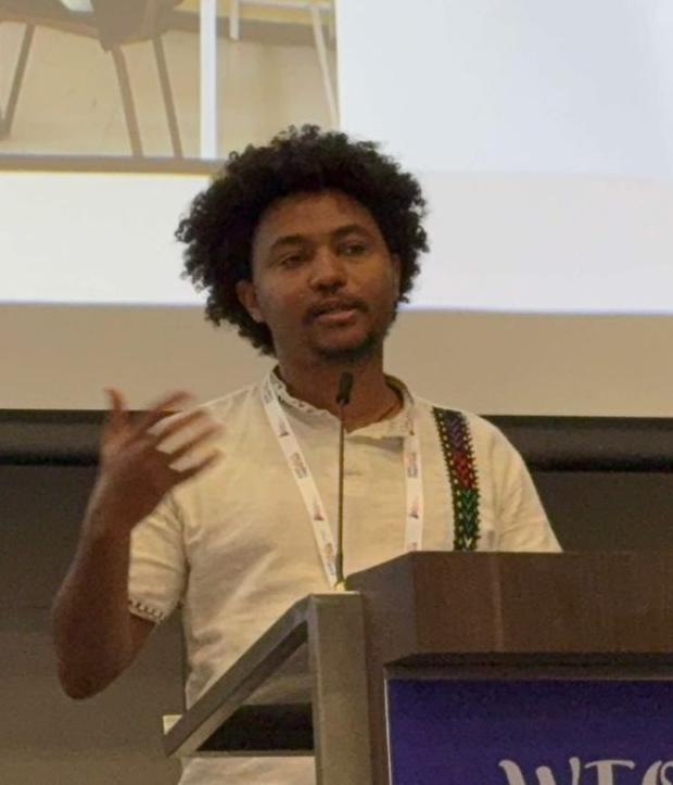 Yohannes speaks at a lectern.