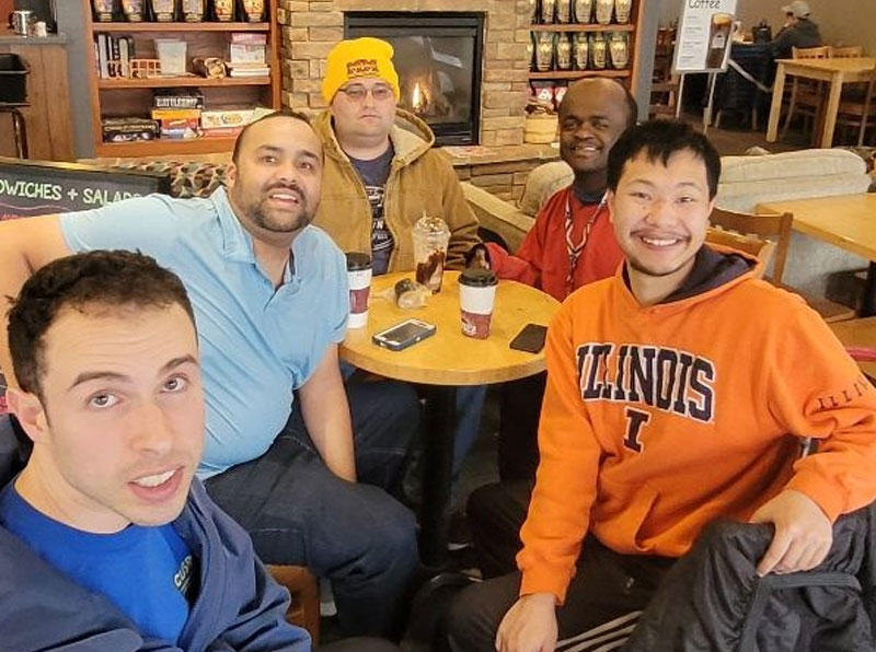5 group members at a coffee shop at a table