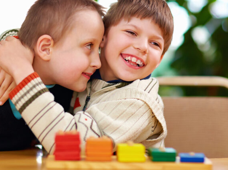two young boys with LD hugging
