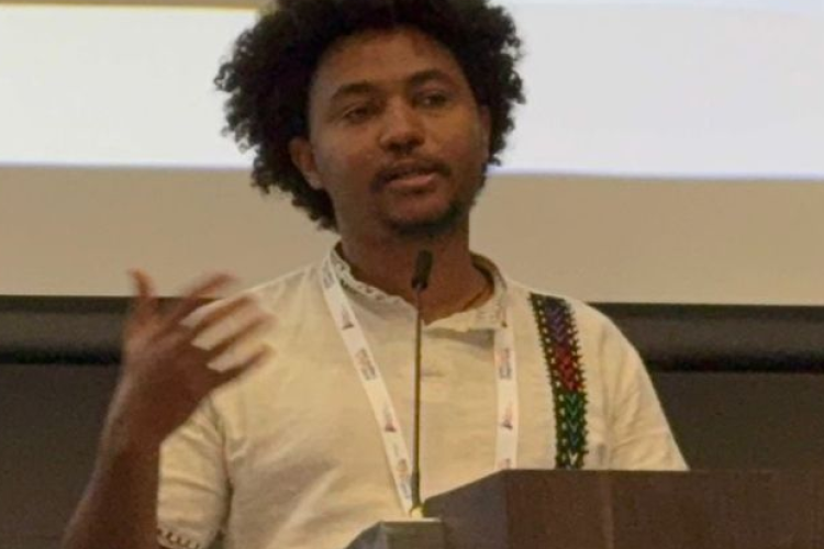 Yohannes speaks at a lectern.